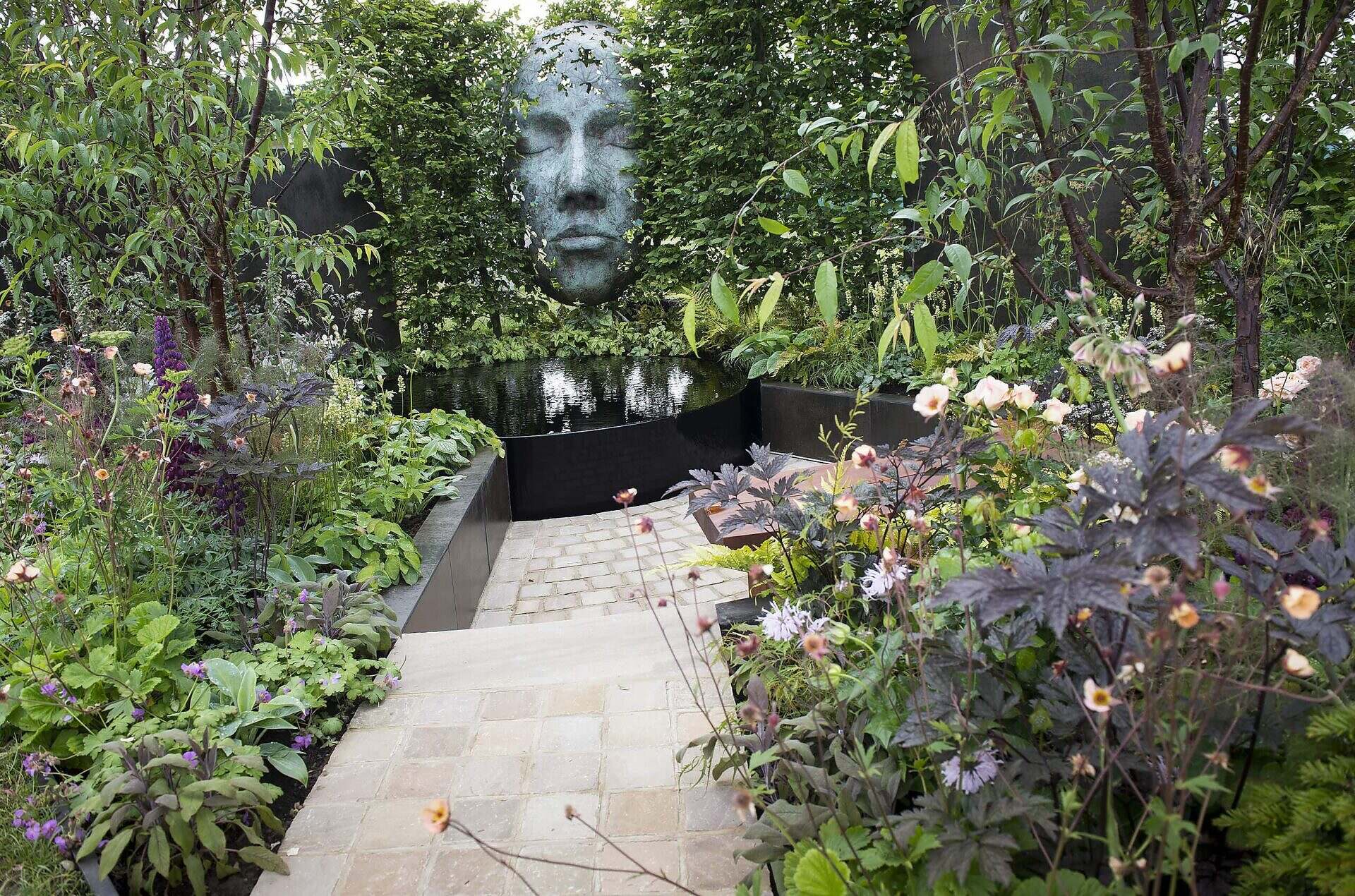 Show garden at RHS Chatsworth showing sculpture